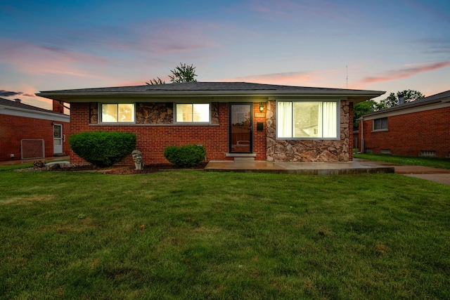 27152 Broadmoor Dr, Warren, MI 48088 - view of front facade with a front yard, stone siding, and brick siding