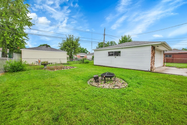 27152 Broadmoor Dr, Warren, MI 48088 - view of yard featuring a fire pit, an outbuilding, concrete driveway, and a detached garage