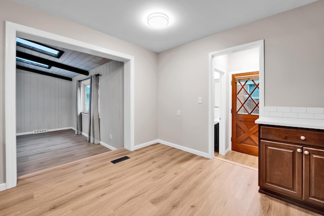 27152 Broadmoor Dr, Warren, MI 48088 - spare room with light wood-type flooring and a skylight