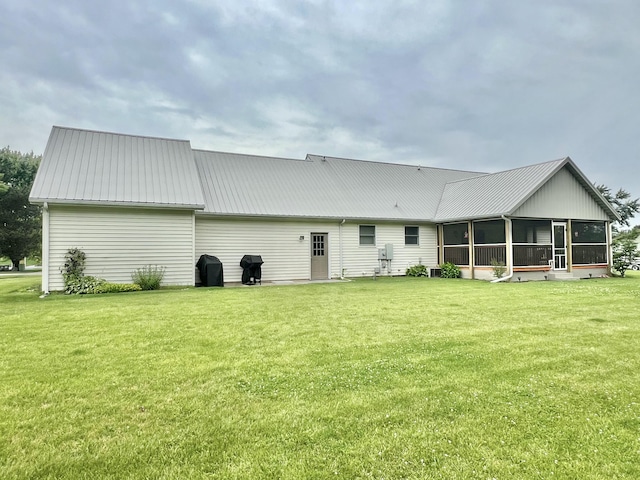 755 Tomahawk Trl, Coldwater, MI 49036 - back of house with a sunroom, a lawn, and a metal roof