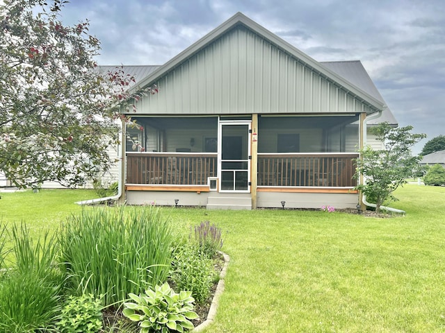 755 Tomahawk Trl, Coldwater, MI 49036 - rear view of property featuring a sunroom, a lawn, and a metal roof