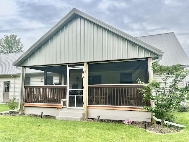 755 Tomahawk Trl, Coldwater, MI 49036 - rear view of house featuring a sunroom, a lawn, and board and batten siding