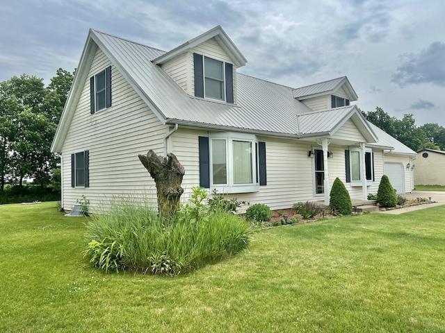 755 Tomahawk Trl, Coldwater, MI 49036 - view of front of home with a front yard, a metal roof, and a garage