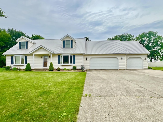 755 Tomahawk Trl, Coldwater, MI 49036 - view of front facade with a garage, concrete driveway, a front yard, and a metal roof