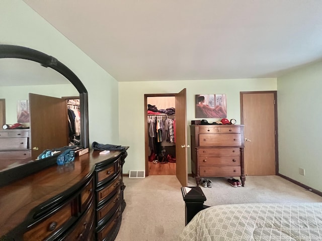 755 Tomahawk Trl, Coldwater, MI 49036 - bedroom with light colored carpet, arched walkways, a walk in closet, and a closet