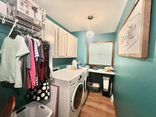 755 Tomahawk Trl, Coldwater, MI 49036 - laundry room featuring washing machine and clothes dryer, cabinet space, and light wood-style flooring