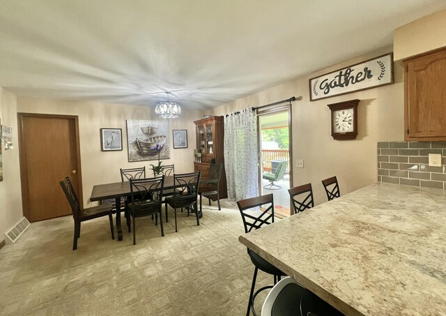 755 Tomahawk Trl, Coldwater, MI 49036 - dining space featuring a chandelier and light carpet