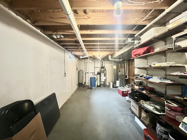 755 Tomahawk Trl, Coldwater, MI 49036 - unfinished basement featuring a water pressure tank, water heater, and heating unit