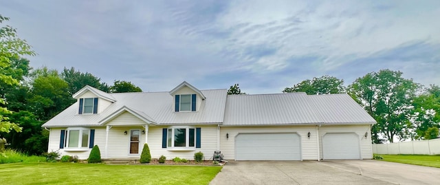 755 Tomahawk Trl, Coldwater, MI 49036 - new england style home with an attached garage, concrete driveway, and a metal roof