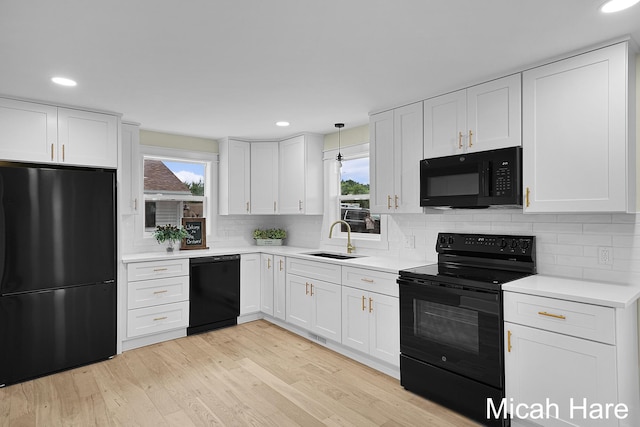 3054 Sehler St, Conklin, MI 49403 - kitchen featuring black appliances, white cabinets, light countertops, and recessed lighting