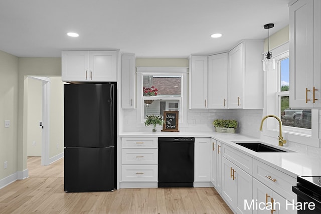 3054 Sehler St, Conklin, MI 49403 - kitchen featuring freestanding refrigerator, black dishwasher, healthy amount of natural light, tasteful backsplash, and recessed lighting