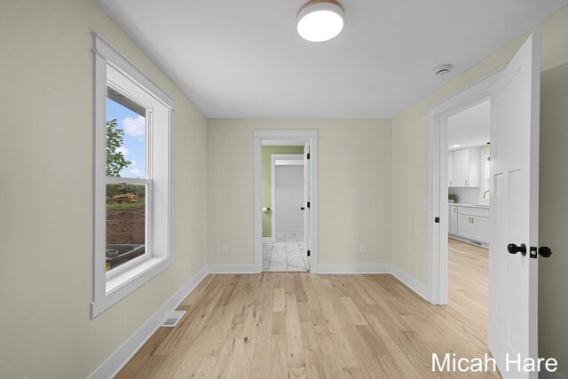 3054 Sehler St, Conklin, MI 49403 - unfurnished room featuring light wood-style floors and a smoke detector