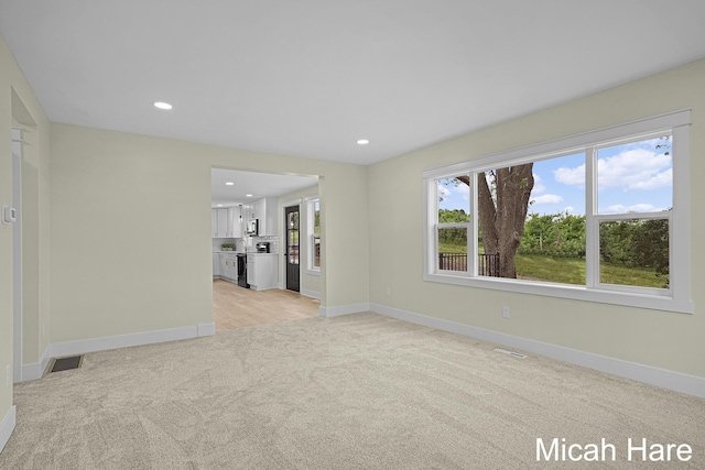 3054 Sehler St, Conklin, MI 49403 - unfurnished living room featuring light carpet and recessed lighting