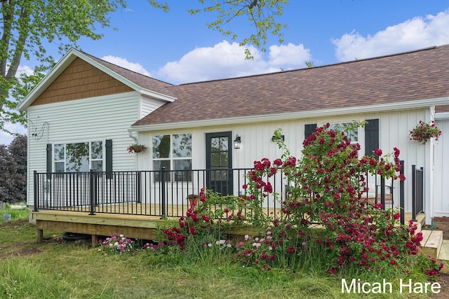 3054 Sehler St, Conklin, MI 49403 - rear view of property with a shingled roof and a wooden deck