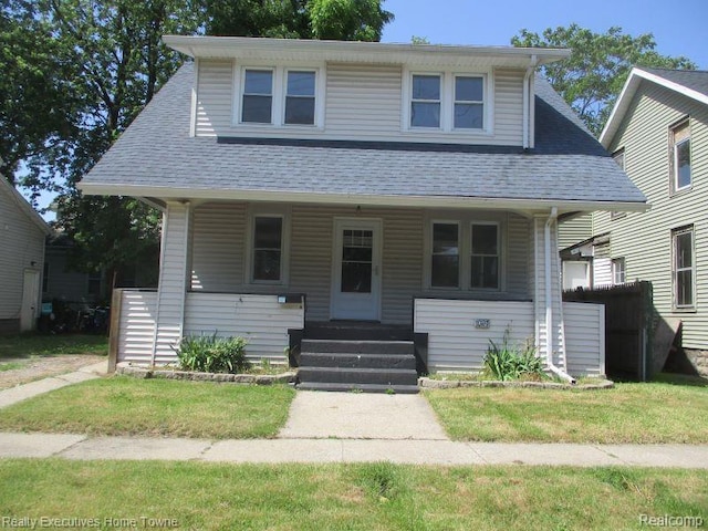 1027 Elmwood St, Port Huron, MI 48060 - bungalow with roof with shingles, covered porch, and a front yard