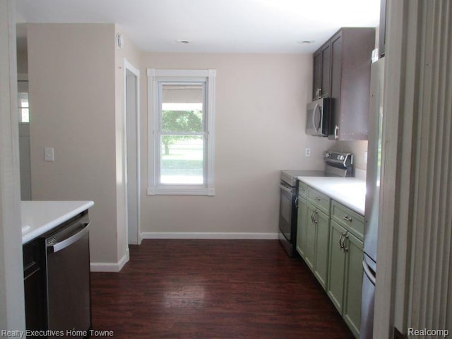 1027 Elmwood St, Port Huron, MI 48060 - kitchen featuring stainless steel appliances, dark wood-style floors, light countertops, and green cabinets