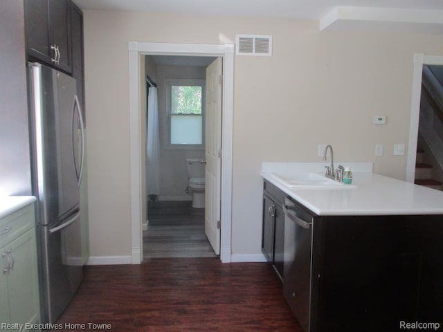 1027 Elmwood St, Port Huron, MI 48060 - kitchen featuring appliances with stainless steel finishes, dark wood-type flooring, and light countertops