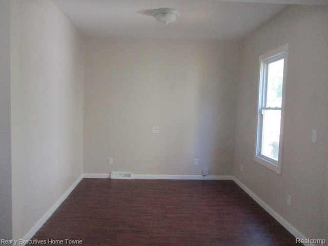 1027 Elmwood St, Port Huron, MI 48060 - spare room with dark wood-style floors and baseboards