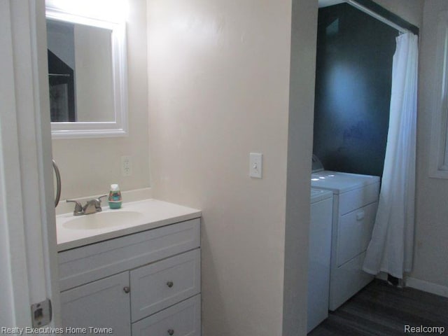 1027 Elmwood St, Port Huron, MI 48060 - bathroom with separate washer and dryer, vanity, and wood finished floors