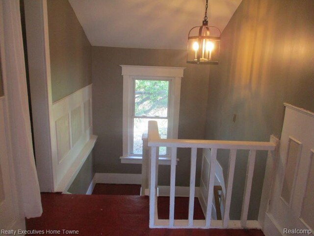 1027 Elmwood St, Port Huron, MI 48060 - stairway featuring a chandelier