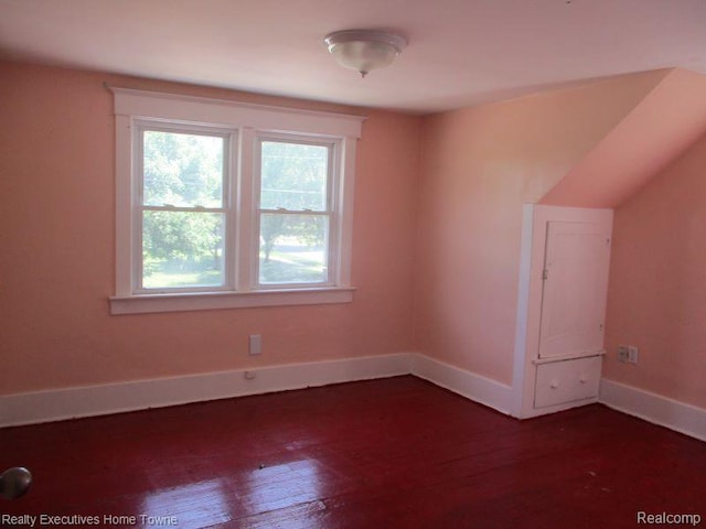 1027 Elmwood St, Port Huron, MI 48060 - bonus room featuring baseboards and dark wood-style floors