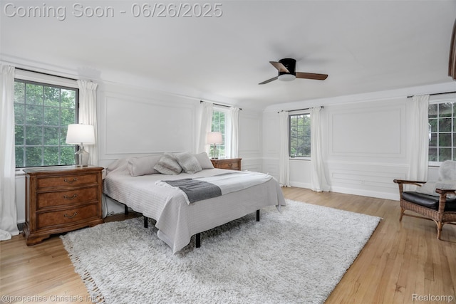 753 Grand Marais St, Grosse Pointe Park, MI 48230 - bedroom with light wood-style floors, a decorative wall, multiple windows, and a ceiling fan