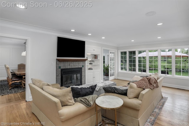753 Grand Marais St, Grosse Pointe Park, MI 48230 - living room featuring ornamental molding, light wood-style flooring, a glass covered fireplace, and recessed lighting