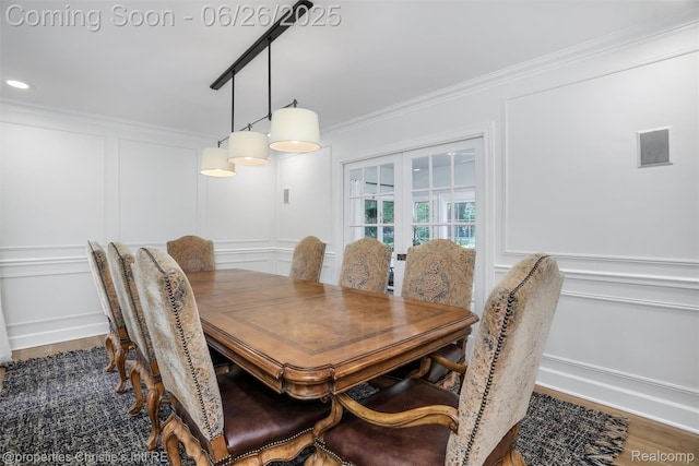 753 Grand Marais St, Grosse Pointe Park, MI 48230 - dining area with a decorative wall, crown molding, and wood finished floors