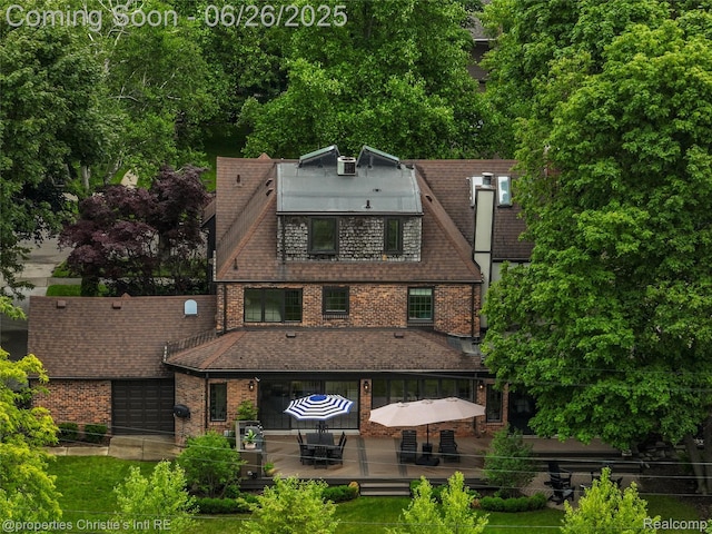 753 Grand Marais St, Grosse Pointe Park, MI 48230 - view of front facade featuring a deck, brick siding, and a garage