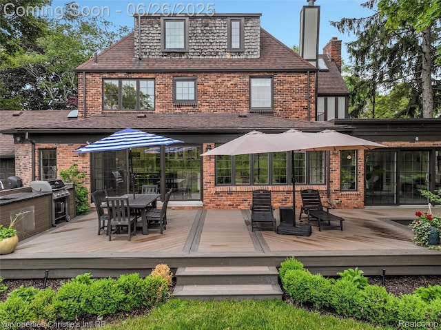 753 Grand Marais St, Grosse Pointe Park, MI 48230 - back of house featuring brick siding, outdoor dining space, and a wooden deck