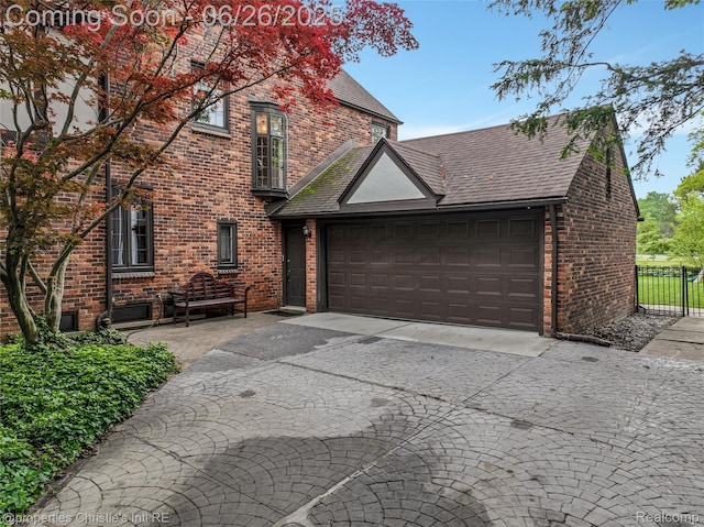 753 Grand Marais St, Grosse Pointe Park, MI 48230 - view of front of home with asphalt driveway, a garage, brick siding, and roof with shingles