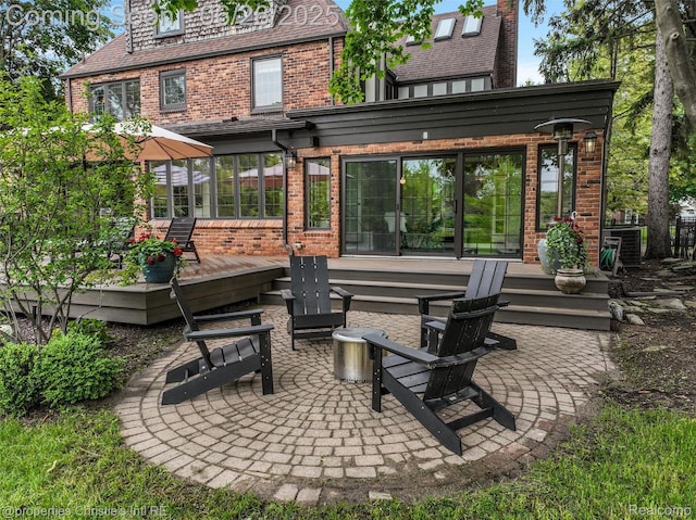 753 Grand Marais St, Grosse Pointe Park, MI 48230 - back of property featuring brick siding, a wooden deck, a patio, and a fire pit