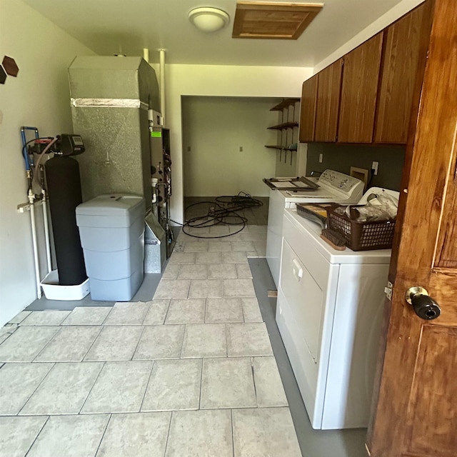 218 W Stover Rd, Standish, MI 48658 - laundry area featuring washing machine and dryer, cabinet space, and light tile patterned floors