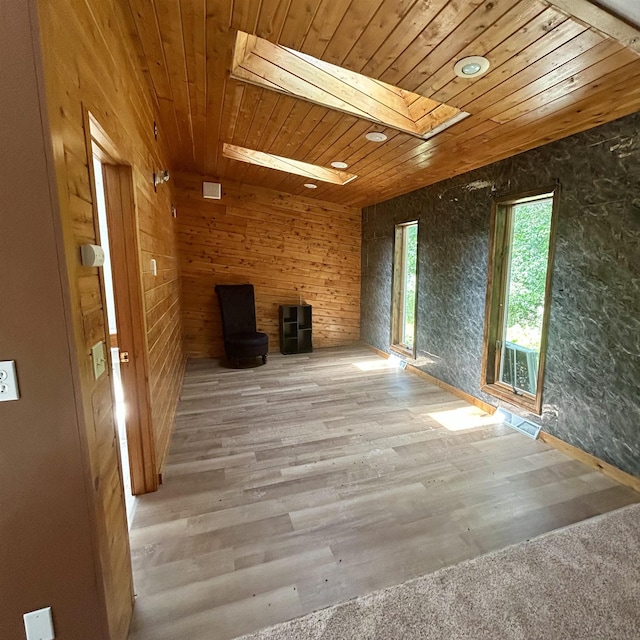 218 W Stover Rd, Standish, MI 48658 - unfurnished living room featuring wooden ceiling, a skylight, and wood finished floors