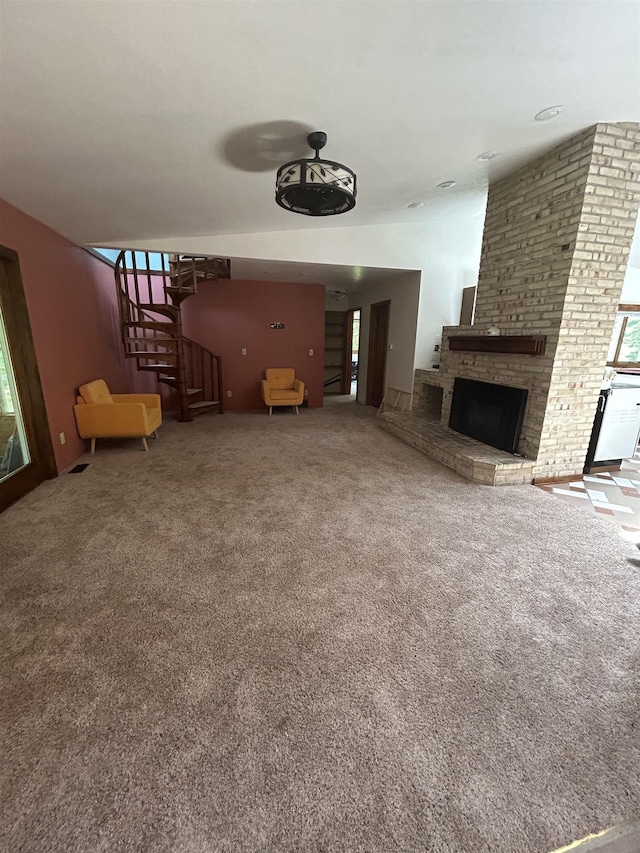218 W Stover Rd, Standish, MI 48658 - unfurnished living room featuring carpet floors, a fireplace, and stairs