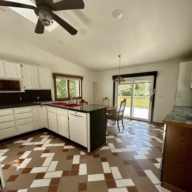 218 W Stover Rd, Standish, MI 48658 - kitchen with dishwasher, dark flooring, dark countertops, healthy amount of natural light, and lofted ceiling