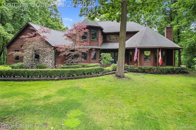 2300 Canyon Ridge Dr, White Lake, MI 48383 - view of front of property featuring a chimney, a front yard, and roof with shingles