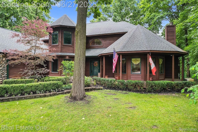 2300 Canyon Ridge Dr, White Lake, MI 48383 - view of front of home with a front yard, a shingled roof, a chimney, and a porch