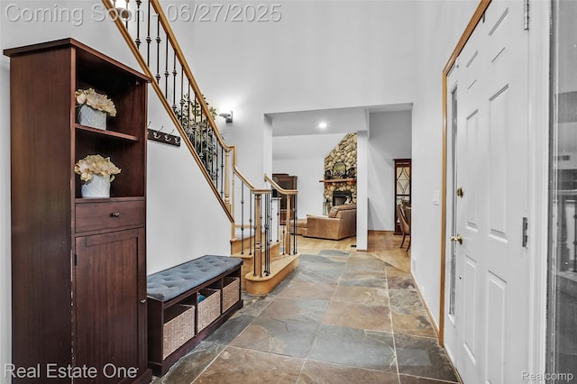 2300 Canyon Ridge Dr, White Lake, MI 48383 - entrance foyer featuring a towering ceiling, stone tile flooring, and stairs