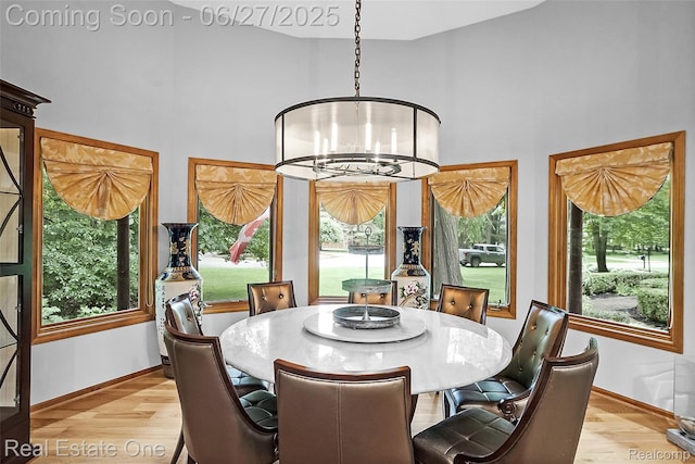 2300 Canyon Ridge Dr, White Lake, MI 48383 - dining room featuring a high ceiling, healthy amount of natural light, a chandelier, and light wood-style flooring