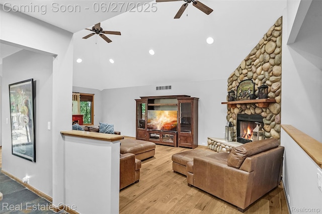 2300 Canyon Ridge Dr, White Lake, MI 48383 - living area with ceiling fan, vaulted ceiling, a stone fireplace, recessed lighting, and light wood-type flooring