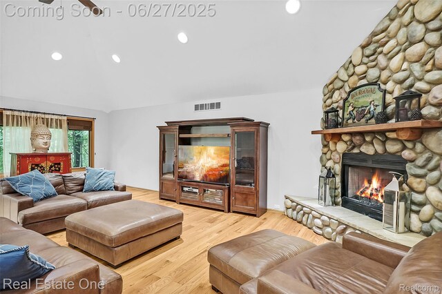 2300 Canyon Ridge Dr, White Lake, MI 48383 - living room featuring vaulted ceiling, a stone fireplace, wood finished floors, and recessed lighting