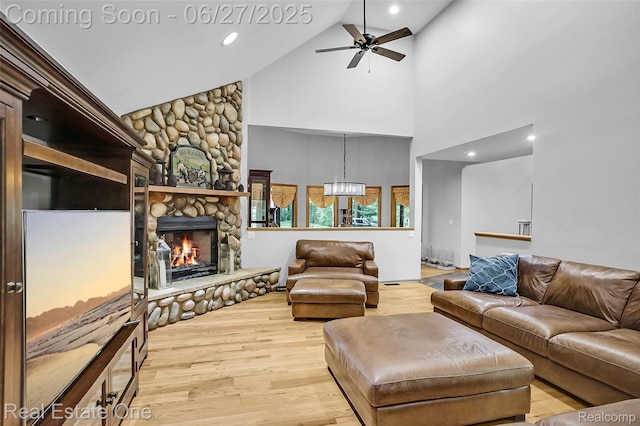 2300 Canyon Ridge Dr, White Lake, MI 48383 - living area featuring high vaulted ceiling, a ceiling fan, wood finished floors, a stone fireplace, and recessed lighting