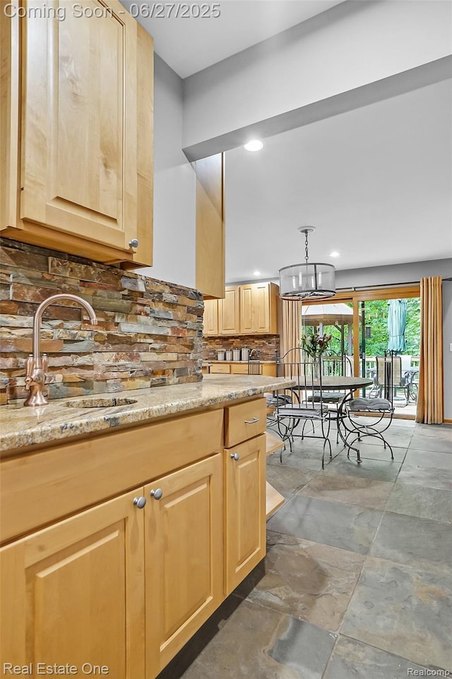 2300 Canyon Ridge Dr, White Lake, MI 48383 - kitchen featuring light brown cabinets, tasteful backsplash, recessed lighting, light stone countertops, and a chandelier