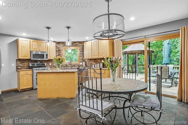 2300 Canyon Ridge Dr, White Lake, MI 48383 - kitchen with stainless steel appliances, light brown cabinetry, backsplash, and recessed lighting