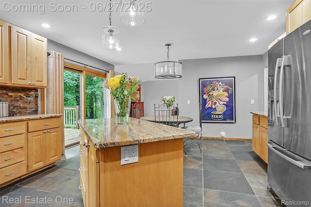 2300 Canyon Ridge Dr, White Lake, MI 48383 - kitchen featuring stainless steel fridge with ice dispenser, a center island, light brown cabinetry, recessed lighting, and light stone countertops