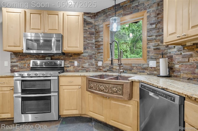 2300 Canyon Ridge Dr, White Lake, MI 48383 - kitchen with appliances with stainless steel finishes, light brown cabinets, tasteful backsplash, light stone counters, and pendant lighting