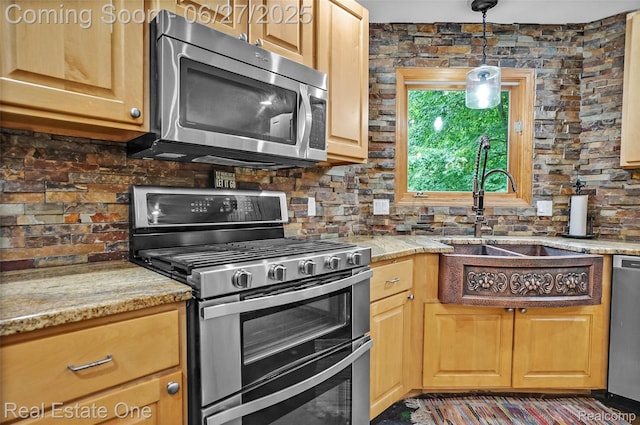 2300 Canyon Ridge Dr, White Lake, MI 48383 - kitchen with stainless steel appliances, backsplash, hanging light fixtures, and light stone counters