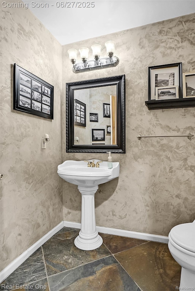 2300 Canyon Ridge Dr, White Lake, MI 48383 - half bathroom featuring baseboards and stone finish flooring
