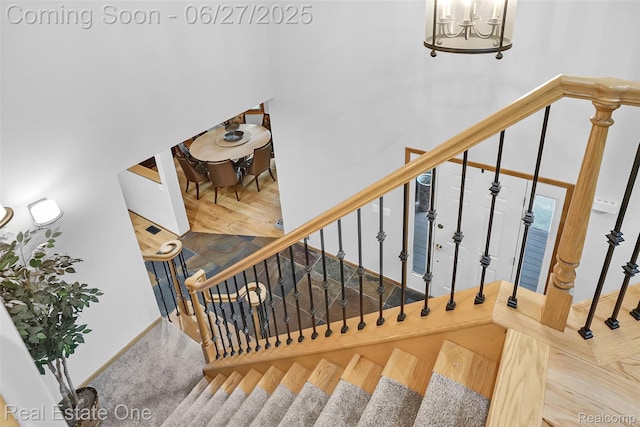 2300 Canyon Ridge Dr, White Lake, MI 48383 - stairs featuring a chandelier and a high ceiling